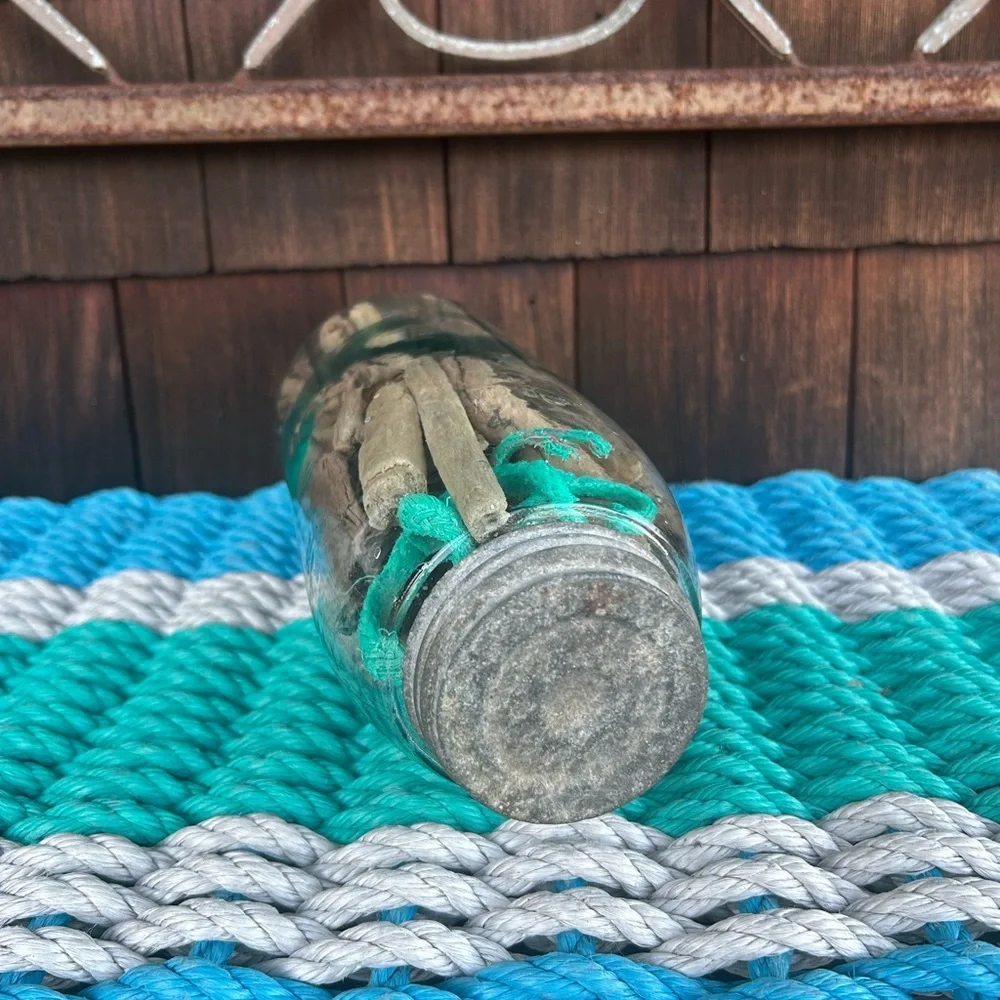 Vintage glass jar with zinc top filled with driftwood and sea rope from Montauk